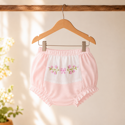 Pink floral embroidered bloomer shorts on hanger