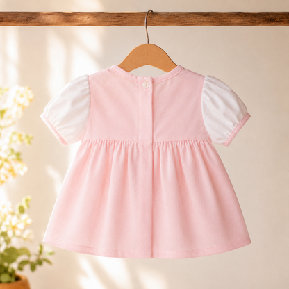 Pink puff sleeve top - back view on hanger